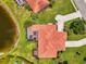 Bird's eye view of the home showing its tile roof, screened lanai and lush landscaping at 2692 Wax Myrtle Ct, Port Charlotte, FL 33953