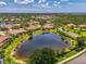 Community aerial view showcasing homes nestled among lush trees and tranquil ponds at 2692 Wax Myrtle Ct, Port Charlotte, FL 33953