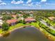 Aerial view of a home in a community with serene ponds and lush green landscaping at 2692 Wax Myrtle Ct, Port Charlotte, FL 33953