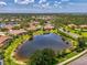 Community aerial view showcasing homes nestled among lush trees and tranquil ponds at 2692 Wax Myrtle Ct, Port Charlotte, FL 33953