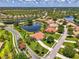 Beautiful aerial view of houses in a lakeside community surrounded by lush greenery and sparkling waters at 2692 Wax Myrtle Ct, Port Charlotte, FL 33953