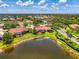 Aerial view of a home in a community with serene ponds and lush green landscaping at 2692 Wax Myrtle Ct, Port Charlotte, FL 33953