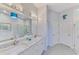 Luxury bathroom with dual sinks, white cabinets, and modern lighting fixtures for a relaxing atmosphere at 2692 Wax Myrtle Ct, Port Charlotte, FL 33953
