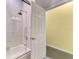 Modern bathroom featuring a glass-enclosed shower over tub at 2692 Wax Myrtle Ct, Port Charlotte, FL 33953