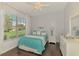 Bright bedroom with large window allowing natural light with a ceiling fan and hardwood flooring at 2692 Wax Myrtle Ct, Port Charlotte, FL 33953