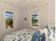 Bright bedroom with view of the outdoor patio and lake at 2692 Wax Myrtle Ct, Port Charlotte, FL 33953