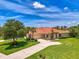 Beautiful single-story home with a red tile roof, well-manicured lawn, and a spacious circular driveway at 2692 Wax Myrtle Ct, Port Charlotte, FL 33953