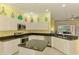 Open kitchen with granite countertops, white cabinets, stainless steel appliances, and island for additional workspace at 2692 Wax Myrtle Ct, Port Charlotte, FL 33953