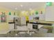 Bright kitchen featuring white cabinets, stainless steel appliances, granite countertops, and access to laundry at 2692 Wax Myrtle Ct, Port Charlotte, FL 33953