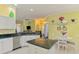 Bright kitchen with granite countertops, white cabinetry, stainless steel appliances, and open to the living area at 2692 Wax Myrtle Ct, Port Charlotte, FL 33953