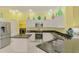 Well-lit kitchen with white cabinets, stainless steel appliances, granite countertops, and easy access to laundry at 2692 Wax Myrtle Ct, Port Charlotte, FL 33953