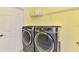 Modern laundry room features front load washer and dryer set and shelving with basket storage at 2692 Wax Myrtle Ct, Port Charlotte, FL 33953