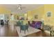 Spacious living room with open layout, wood floors, comfortable seating, and access to the kitchen at 2692 Wax Myrtle Ct, Port Charlotte, FL 33953
