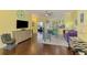Open-concept living space with stylish decor, wood flooring, and seamless transitions between living, dining, and kitchen areas at 2692 Wax Myrtle Ct, Port Charlotte, FL 33953