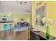 Open-concept living area with stylish decor, modern lighting, and bright yellow walls at 2692 Wax Myrtle Ct, Port Charlotte, FL 33953