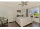 Serene main bedroom with a queen-size bed, decorative ceiling fan, and view of the pool area at 2692 Wax Myrtle Ct, Port Charlotte, FL 33953