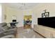 Home office area with a large TV and view of a living area for a flexible living space at 2692 Wax Myrtle Ct, Port Charlotte, FL 33953