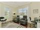 Cozy office featuring hardwood floors, a starfish rug, large windows, and comfortable seating at 2692 Wax Myrtle Ct, Port Charlotte, FL 33953