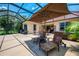 Screened in patio includes exterior kitchen and lounge chairs, hot tub and plants at 2692 Wax Myrtle Ct, Port Charlotte, FL 33953