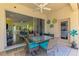 Covered patio includes table with seating overlooking interior living area and bedroom at 2692 Wax Myrtle Ct, Port Charlotte, FL 33953