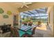 Enjoy outdoor dining on screened patio with beautiful water view and ceiling fan at 2692 Wax Myrtle Ct, Port Charlotte, FL 33953