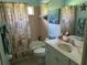 Bathroom with a single marble sink, toilet, bathtub with shower, and starfish decor at 2864 Traverse Ave, North Port, FL 34286