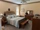 This bedroom features a decorative floral-themed border, ceiling fan, and coordinated bedspread and pillow set at 2864 Traverse Ave, North Port, FL 34286
