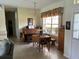 Inviting dining area featuring a rolltop piano, classic chandelier, and ample natural light from the nearby window at 2864 Traverse Ave, North Port, FL 34286