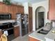 Galley kitchen featuring stainless steel appliances, granite countertops, and plenty of cabinet space at 2864 Traverse Ave, North Port, FL 34286