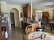 Well-lit kitchen featuring light countertops, wood cabinets and open to the living room at 2864 Traverse Ave, North Port, FL 34286