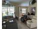 Comfortable living room featuring a large window with a pool view, neutral color palette, and tile flooring at 2864 Traverse Ave, North Port, FL 34286