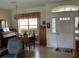 Living room featuring tile flooring, a chandelier, a front door view and a dining area at 2864 Traverse Ave, North Port, FL 34286