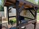 Covered outdoor grilling area with brick patio and dark wooden structure, perfect for entertaining at 2864 Traverse Ave, North Port, FL 34286