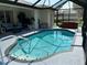Enjoy this screened-in pool area with hot tub, ceiling fan, and ample room for entertaining and relaxing at 2864 Traverse Ave, North Port, FL 34286