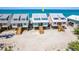 Aerial view showcasing charming beachfront homes on stilts, offering stunning ocean views at 301 S Gulf Blvd # 3, Placida, FL 33946