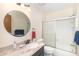 Bright bathroom featuring a marble countertop and sliding glass door shower at 301 S Gulf Blvd # 3, Placida, FL 33946
