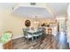 Open dining area with hardwood floors, a table for six, and a view into the kitchen at 301 S Gulf Blvd # 3, Placida, FL 33946