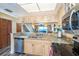 Cozy kitchen with granite countertops, stainless appliances, and a pass-through to living area at 301 S Gulf Blvd # 3, Placida, FL 33946
