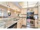 Bright kitchen featuring granite countertops, stainless steel appliances, and ample cabinet space at 301 S Gulf Blvd # 3, Placida, FL 33946