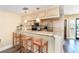 Kitchen with a breakfast bar featuring wood stools, granite counters, and stainless appliances at 301 S Gulf Blvd # 3, Placida, FL 33946
