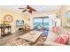 Comfortable living room boasts a ceiling fan and sliding doors that reveal beach views at 301 S Gulf Blvd # 3, Placida, FL 33946