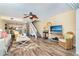 Relaxing living room with a beach view on TV, wicker chairs and a decorative ceiling fan at 301 S Gulf Blvd # 3, Placida, FL 33946
