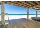 Wood-planked deck for outdoor living, overlooking a sandy beach and the ocean at 301 S Gulf Blvd # 3, Placida, FL 33946