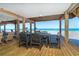 Under-house outdoor dining with seating for six, view to ocean beach at 301 S Gulf Blvd # 3, Placida, FL 33946