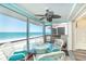 Screened-in porch with table and chairs, showcases stunning ocean views, and a calming atmosphere at 301 S Gulf Blvd # 3, Placida, FL 33946