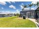 Well-manicured backyard featuring a pool, lush grass, and scenic waterfront views, perfect for outdoor activities and relaxation at 3025 Curry Ter, Port Charlotte, FL 33981