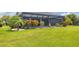 This backyard offers a pool area, a spacious lawn, and colorful landscaping, creating an inviting and picturesque outdoor setting at 3025 Curry Ter, Port Charlotte, FL 33981