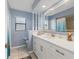 Stylish bathroom featuring double sink vanity, framed mirror, and natural light at 3025 Curry Ter, Port Charlotte, FL 33981