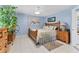 Calming bedroom featuring wooden furniture, tile floors, and cool blue walls at 3025 Curry Ter, Port Charlotte, FL 33981