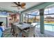 Bright dining area with pool view, ceiling fan, and comfortable wicker chairs, perfect for enjoying meals and entertaining at 3025 Curry Ter, Port Charlotte, FL 33981